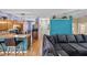 Cozy living area flows into the kitchen and entryway, featuring an extra large couch and hardwood floors at 411 Ryans Ridge Ave, Eustis, FL 32726