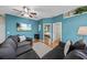 Inviting living room featuring a comfortable gray sofa, ceiling fan, and beach-themed wall art at 411 Ryans Ridge Ave, Eustis, FL 32726