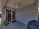 Covered outdoor patio with ceiling fan and sliding glass doors leading to the interior at 411 Ryans Ridge Ave, Eustis, FL 32726