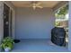 Covered patio featuring a ceiling fan, grill, and sliding glass doors leading inside at 411 Ryans Ridge Ave, Eustis, FL 32726