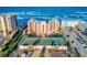 Aerial view of beachfront condo building with tennis courts and ocean views at 4141 S Atlantic Ave # 605, New Smyrna Beach, FL 32169