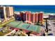 Picturesque setting of tennis courts, parking, complex, nearby neighborhood, and ocean view at 4141 S Atlantic Ave # 605, New Smyrna Beach, FL 32169