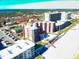 Aerial view of condominiums with a pool, parking, and beach access at 4141 S Atlantic Ave # 605, New Smyrna Beach, FL 32169