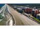 An aerial shot of a sandy beach and condominiums with beach access at 4141 S Atlantic Ave # 605, New Smyrna Beach, FL 32169