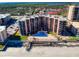 Aerial view of a condo building with a pool and beach access at 4141 S Atlantic Ave # 605, New Smyrna Beach, FL 32169