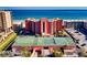 Overhead view of complex shows manicured tennis courts, with direct ocean views and convenient parking at 4141 S Atlantic Ave # 605, New Smyrna Beach, FL 32169