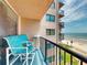 Comfortable balcony with chairs, a small table and scenic ocean views at 4141 S Atlantic Ave # 605, New Smyrna Beach, FL 32169