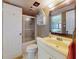 This bathroom includes a vanity with mirror, toilet, and shower with glass door at 4141 S Atlantic Ave # 605, New Smyrna Beach, FL 32169