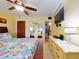 Bright bedroom with tile floors, ceiling fan, closet and flat screen TV, plus adjacent bathroom at 4141 S Atlantic Ave # 605, New Smyrna Beach, FL 32169