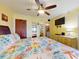 Inviting bedroom with ceiling fan, TV, closet, ensuite bath, and beachy decor at 4141 S Atlantic Ave # 605, New Smyrna Beach, FL 32169
