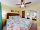 Bright bedroom boasts a ceiling fan, ocean-themed bedding, and warm yellow walls at 4141 S Atlantic Ave # 605, New Smyrna Beach, FL 32169