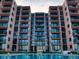 Symmetrical building facade with multiple balconies overlooks a refreshing pool, perfect for enjoying the outdoors at 4141 S Atlantic Ave # 605, New Smyrna Beach, FL 32169
