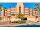 Exterior view of a multi-story beachfront condo building with palm trees at 4141 S Atlantic Ave # 605, New Smyrna Beach, FL 32169
