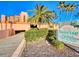 Inviting Sunrise Rentals complex featuring lush landscaping, a covered parking garage, and a clear blue sky at 4141 S Atlantic Ave # 605, New Smyrna Beach, FL 32169