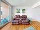 Living room with hardwood floors, and a view of the balcony at 4141 S Atlantic Ave # 605, New Smyrna Beach, FL 32169