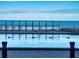 A relaxing beachfront pool with lounge chairs at 4141 S Atlantic Ave # 605, New Smyrna Beach, FL 32169