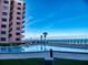 A beachfront pool with palm trees at 4141 S Atlantic Ave # 605, New Smyrna Beach, FL 32169