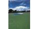 Outdoor tennis court featuring bright green surface and blue-and-white playing area at 4141 S Atlantic Ave # 605, New Smyrna Beach, FL 32169