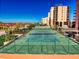 Aerial shot of well-maintained tennis courts offering recreational opportunities with a building view in the background at 4141 S Atlantic Ave # 605, New Smyrna Beach, FL 32169