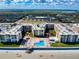 Eye-level aerial view of beach condos featuring a swimming pool and landscaped common area at 4175 S Atlantic Ave # 4110, New Smyrna Beach, FL 32169