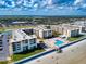 Lovely aerial view of beachfront condominiums, pool area, and ocean access at 4175 S Atlantic Ave # 4110, New Smyrna Beach, FL 32169