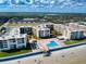 Bright aerial shot of condos with a swimming pool, shuffleboard, and ocean beach at 4175 S Atlantic Ave # 4110, New Smyrna Beach, FL 32169