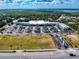An aerial view of the neighborhood featuring shops with ample parking and greenery at 4175 S Atlantic Ave # 4110, New Smyrna Beach, FL 32169