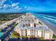 Stunning aerial view of beachfront condos with pristine sands and blue ocean waves at 4175 S Atlantic Ave # 4110, New Smyrna Beach, FL 32169