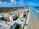 Serene aerial scene of condos nestled along the beach, highlighting lush landscaping at 4175 S Atlantic Ave # 4110, New Smyrna Beach, FL 32169