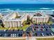 Aerial view of beachfront condos with parking and well-kept landscaping at 4175 S Atlantic Ave # 4110, New Smyrna Beach, FL 32169