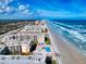 Beautiful aerial shot of condo community, showcasing a pool and beach access at 4175 S Atlantic Ave # 4110, New Smyrna Beach, FL 32169