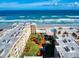 Aerial view showcasing beachfront condos, manicured lawns and a swimming pool at 4175 S Atlantic Ave # 4110, New Smyrna Beach, FL 32169