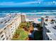 Aerial view of beachfront condos, manicured landscaping, pool, and ocean views at 4175 S Atlantic Ave # 4110, New Smyrna Beach, FL 32169