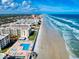 Scenic aerial view of beachfront condos, capturing the beauty of the ocean waves at 4175 S Atlantic Ave # 4110, New Smyrna Beach, FL 32169