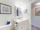 Bright bathroom featuring a white vanity with a mirror and coastal-themed decor at 4175 S Atlantic Ave # 4110, New Smyrna Beach, FL 32169