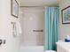 Clean bathroom with a white tiled shower, grab bar, and light blue shower curtain at 4175 S Atlantic Ave # 4110, New Smyrna Beach, FL 32169