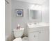 Bathroom with white vanity, toilet and simple decor featuring seashells at 4175 S Atlantic Ave # 4110, New Smyrna Beach, FL 32169