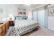 Bright bedroom featuring a comfortable bed with seahorse patterned bedding and beach themed wall art at 4175 S Atlantic Ave # 4110, New Smyrna Beach, FL 32169