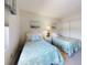 Charming bedroom with twin beds featuring beach-themed decor and a closet at 4175 S Atlantic Ave # 4110, New Smyrna Beach, FL 32169