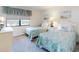 Cozy bedroom featuring two twin beds with coastal-themed bedding and a view from the window at 4175 S Atlantic Ave # 4110, New Smyrna Beach, FL 32169