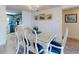 Bright dining area with seating for six opens to kitchen with beautiful blue cabinetry at 4175 S Atlantic Ave # 4110, New Smyrna Beach, FL 32169