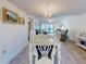 Elegant dining room with chandelier and beautiful views of the living area and balcony at 4175 S Atlantic Ave # 4110, New Smyrna Beach, FL 32169