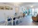 Bright dining area featuring a chandelier and seating for six with sliding door balcony access at 4175 S Atlantic Ave # 4110, New Smyrna Beach, FL 32169