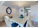 Bright dining area with seating for six opens to kitchen with beautiful blue cabinetry at 4175 S Atlantic Ave # 4110, New Smyrna Beach, FL 32169