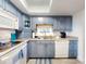 Cozy kitchen featuring updated appliances and beautiful blue cabinets at 4175 S Atlantic Ave # 4110, New Smyrna Beach, FL 32169