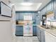 Cozy kitchen featuring updated appliances and beautiful blue cabinets at 4175 S Atlantic Ave # 4110, New Smyrna Beach, FL 32169