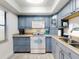 Cozy kitchen featuring updated appliances and beautiful blue cabinets and a skylight at 4175 S Atlantic Ave # 4110, New Smyrna Beach, FL 32169