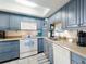 Cozy kitchen featuring updated appliances and beautiful blue cabinets at 4175 S Atlantic Ave # 4110, New Smyrna Beach, FL 32169