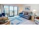 Living room with a sofa, TV, and balcony access featuring ocean views at 4175 S Atlantic Ave # 4110, New Smyrna Beach, FL 32169