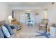 Open-concept living room with modern furniture and a glimpse into the kitchen and dining area at 4175 S Atlantic Ave # 4110, New Smyrna Beach, FL 32169